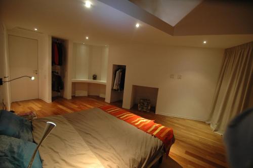 a bedroom with a bed and a couch in it at Holiday home Isola Rossa in Isola Rossa