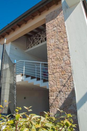 a house with a staircase on the side of it at Holiday home Isola Rossa in Isola Rossa