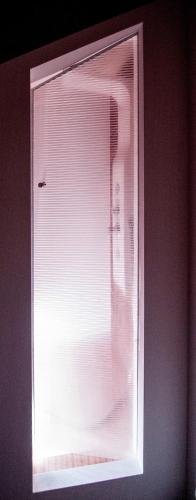 a window with blinds on it in a room at Holiday home Isola Rossa in Isola Rossa