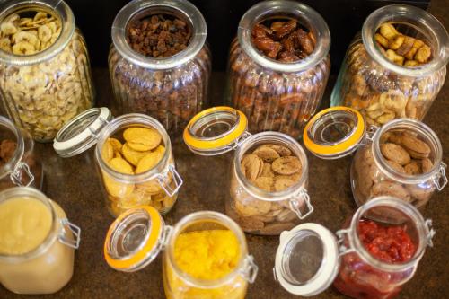 a group of jars filled with different types of food at Grupotel Mar de Menorca in Es Canutells