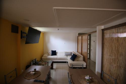 a living room with a white couch and tables at AH Hotel in Antofagasta
