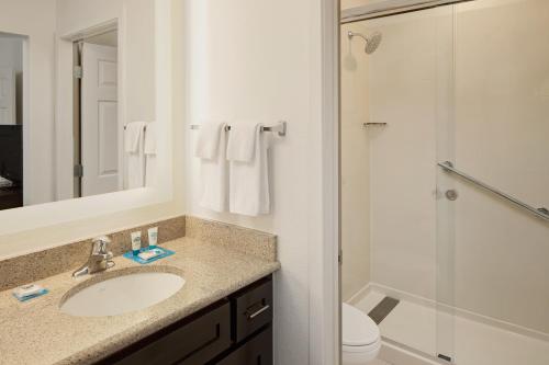 a bathroom with a sink and a shower and a toilet at Hyatt House Dallas Addison in Addison