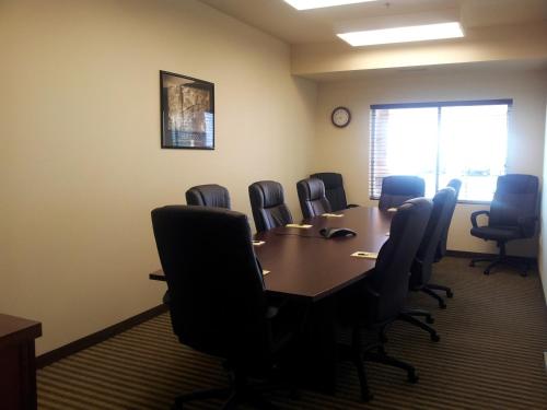 a conference room with a table and chairs at Extended Stay Americas Suites - Minot in Minot