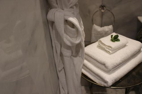 a pile of towels on a table in a bathroom at The Gregoire Boutique Villa in Hermanus