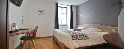 a bedroom with a bed and a desk and a window at Best Western Le Pont d'Or in Figeac