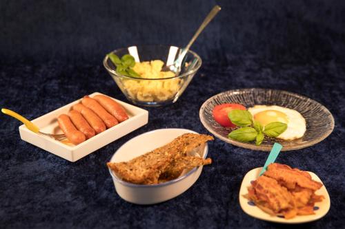 a table with plates of food and bowls of food at Bed & Breakfast Horsens in Horsens