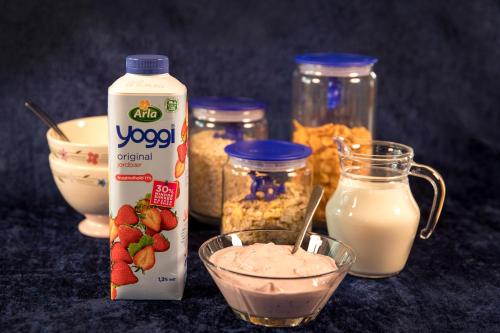 a table with jars of yogurt and a bottle of milk at Bed & Breakfast Horsens in Horsens