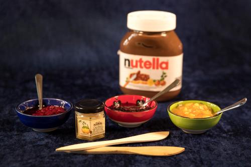 a group of bowls of food and a jar of nutella at Bed & Breakfast Horsens in Horsens