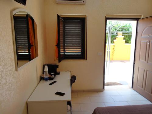 a room with a desk and a door to a yard at Anema e Core Pizzo in Pizzo