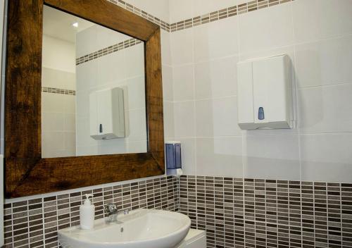 a bathroom with a sink and a mirror at Cristal Rooms in Piacenza