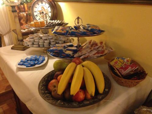 a table with bananas apples and other food on it at Torre Sangiovanni Albergo e Ristorante da Rosary in Todi