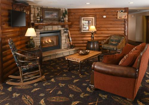 a living room with a couch and a fireplace at Stoney Creek Hotel Wausau - Rothschild in Rothschild