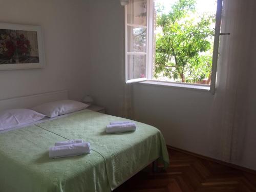 a bedroom with a bed with two towels on it at Apartment Dubcic: For perfect vacation in Dubrovnik