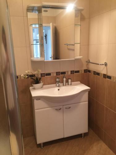 a bathroom with a white sink and a mirror at Apartment Dubcic: For perfect vacation in Dubrovnik