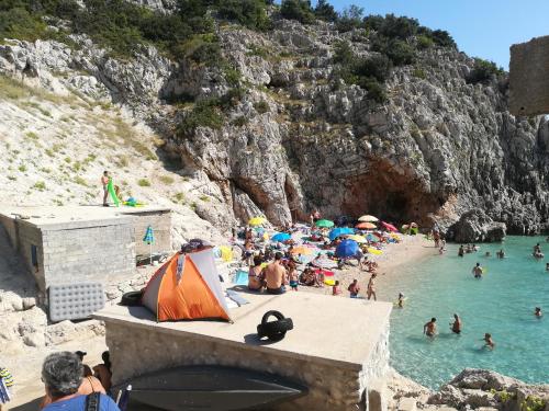 a group of people in the water at a beach at Apartment Natali in Brseč