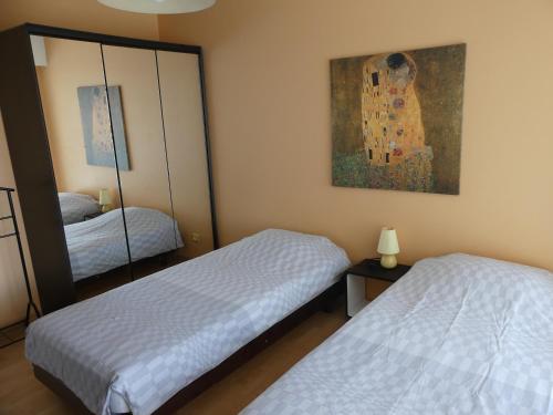 a bedroom with two beds and a painting on the wall at Apartment Montmorency in Cannes