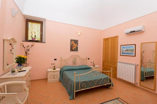 a bedroom with a bed and a sink and a mirror at Villa Anna in Minori