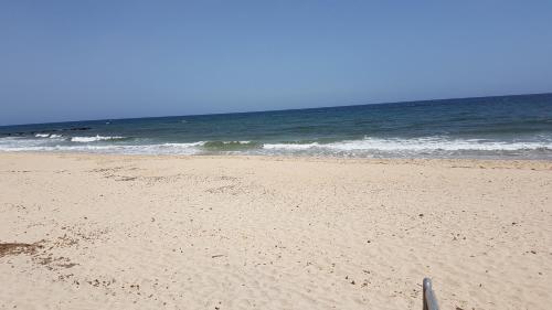 a sandy beach with the ocean in the background at Mare a Santa Margherita in Pula