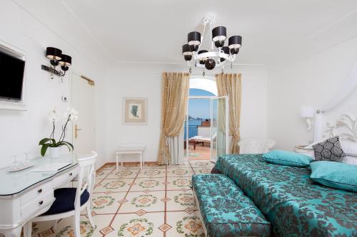 a bedroom with a bed and a desk at Villa Corallium in Praiano