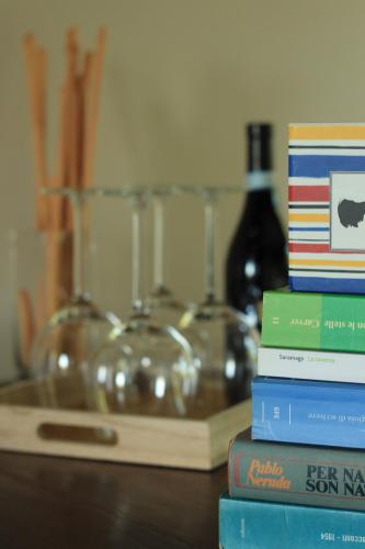 a stack of books sitting on top of a table at La Basiglia Apartment in Monforte dʼAlba