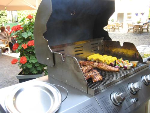 a grill with some meat and vegetables on it at Hotel Marienhof Baumberge in Nottuln