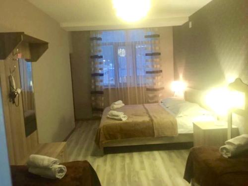 a hotel room with two beds and a window at Apartment Jorjo Mestia in Mestia