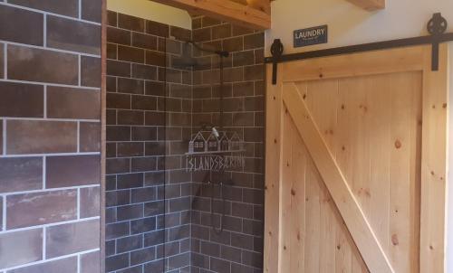 a barn door in a house with a brick wall at Íslandsbærinn /Old Farm in Akureyri