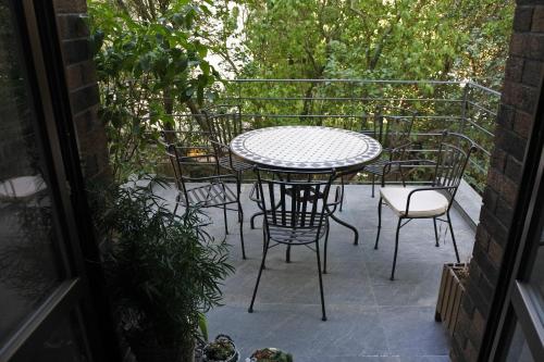 a table and chairs sitting on a patio at APARTMÁN V ZAHRADĚ PRAHA TROJA - APARTMENT IN THE GARDEN PRAGUE Troja in Prague