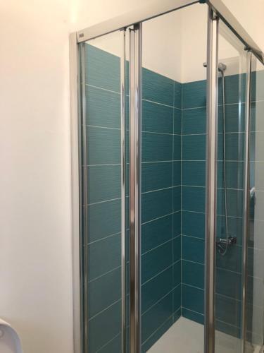 a shower with blue tile in a bathroom at Yasmina in Lajares