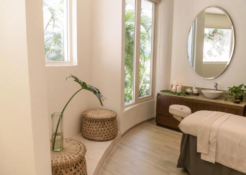 a bathroom with a sink and a mirror at Grand Miramar All Luxury Suites & Residences in Puerto Vallarta