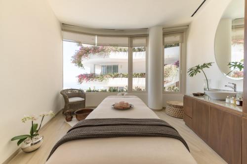 a bedroom with a large bed and a large window at Grand Miramar All Luxury Suites & Residences in Puerto Vallarta