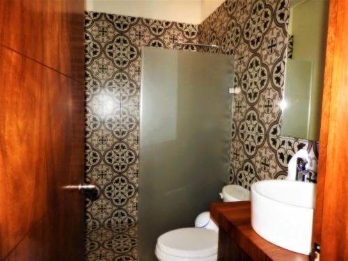 a bathroom with a toilet and a sink at Villas La Ceiba in Playa del Carmen