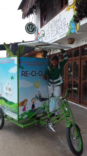 a person standing next to a bike with a cart at Eco Hotel El Refugio Boutique in Leticia