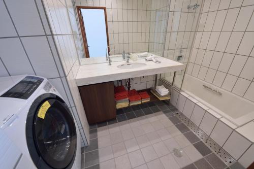 a bathroom with a sink and a washing machine at Kyoto - house / Vacation STAY 1099 in Kyoto