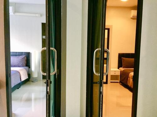 a door leading to a bedroom with a bed at Baan Fran Sim Da in Bang Tao Beach