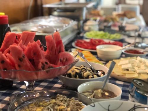a table topped with lots of different types of food at Garni Hotel Lake in Čačak
