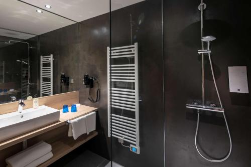 a bathroom with a sink and a shower at Best Western Plus Hotel & SPA Le Schoenenbourg in Riquewihr