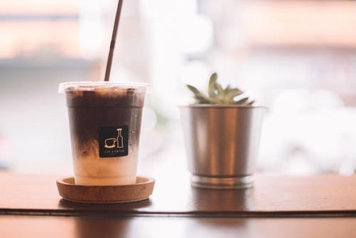 two cups of coffee sitting on a table at Bed & Bike Hostel in Chiang Rai