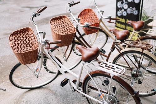 two bikes parked next to each other with baskets on them at Bed & Bike Hostel in Chiang Rai