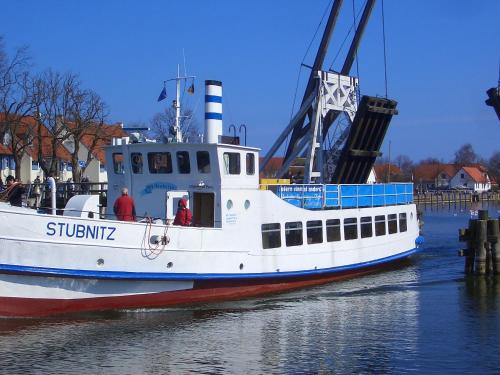a boat in the water with a crane at Hotel zur Brücke in Greifswald