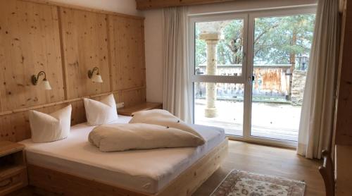 a bedroom with a bed and a large window at Terra Rossa in Fiss