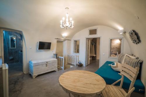 a living room with a table and a couch at Kaleidoscope Cave Houses in Oia