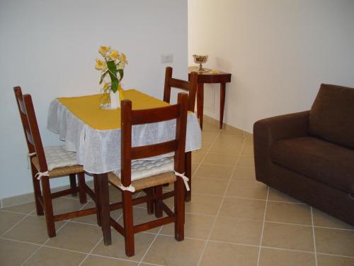 a table and chairs with a table and a couch at B&B Dell' Artista in Artena