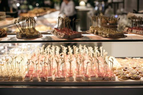 a display case with many different types of pastries at Hotel Aloisi in Lecce