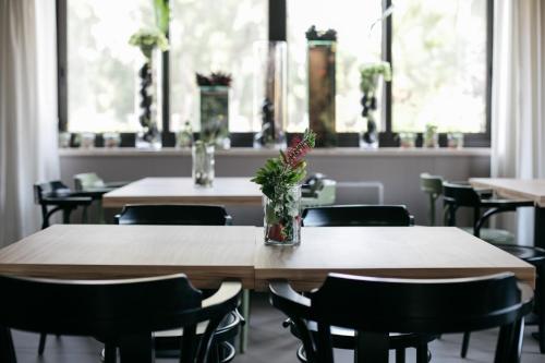a table with a vase of flowers on top of it at Hotel Aloisi in Lecce