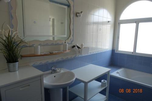 a bathroom with a sink and a mirror and a tub at Princ Gabi in Málaga