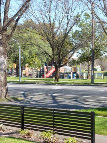 a park bench sitting on the side of a street at Tea House Motor Inn in Bendigo