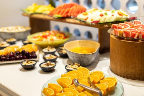 a buffet of food with oranges and other fruits at Inturotel Cala Esmeralda Beach Hotel & Spa - Adults Only in Cala d´Or