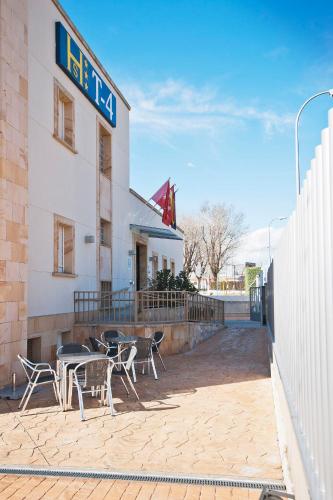 a restaurant with tables and chairs outside of a building at Hostal T4 in Paracuellos de Jarama