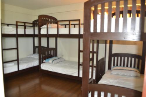 a room with three bunk beds in a room at Metro Vigan Inn in Vigan